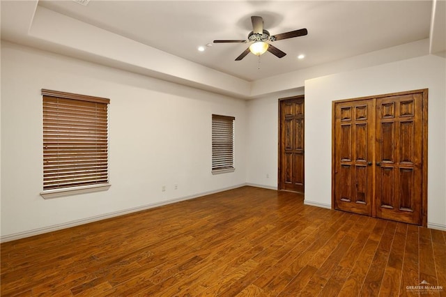 unfurnished bedroom featuring dark hardwood / wood-style floors and ceiling fan