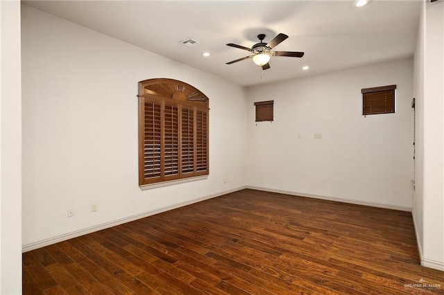 empty room with dark hardwood / wood-style floors and ceiling fan