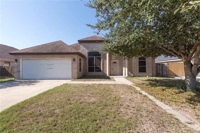 view of front of house with a garage and a front lawn