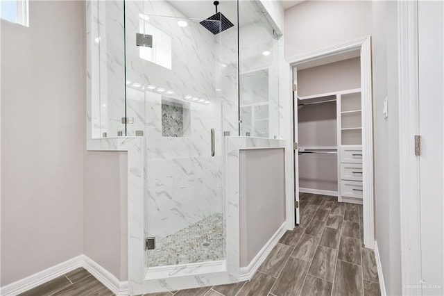 bathroom with a shower with door