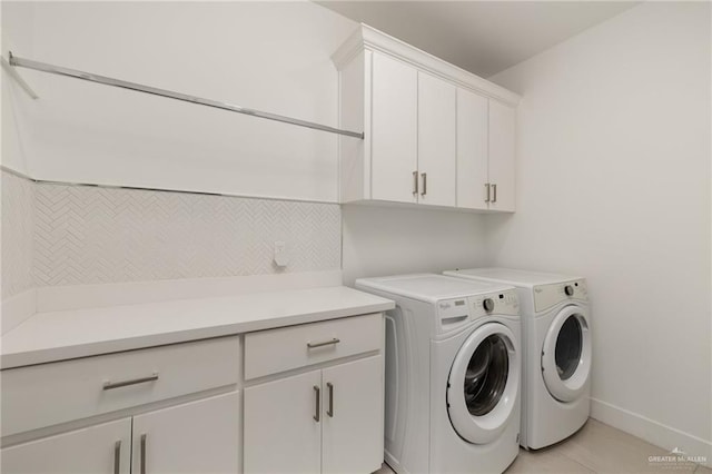 laundry room featuring cabinet space, independent washer and dryer, baseboards, and light tile patterned floors