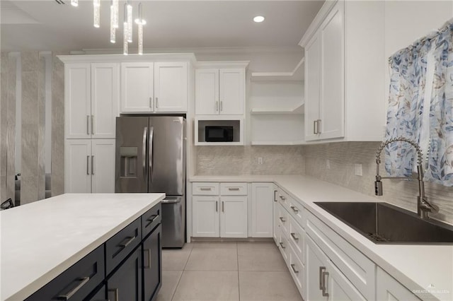 kitchen featuring stainless steel fridge with ice dispenser, open shelves, a sink, white cabinets, and recessed lighting