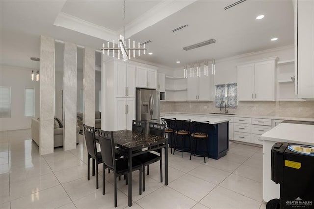dining space featuring crown molding, a chandelier, light tile patterned flooring, and recessed lighting