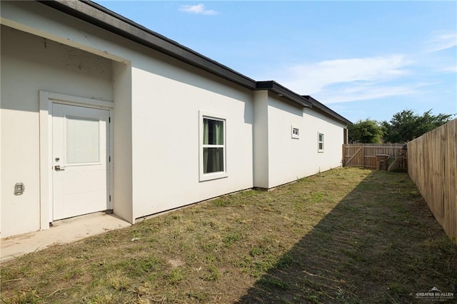 view of side of property featuring stucco siding