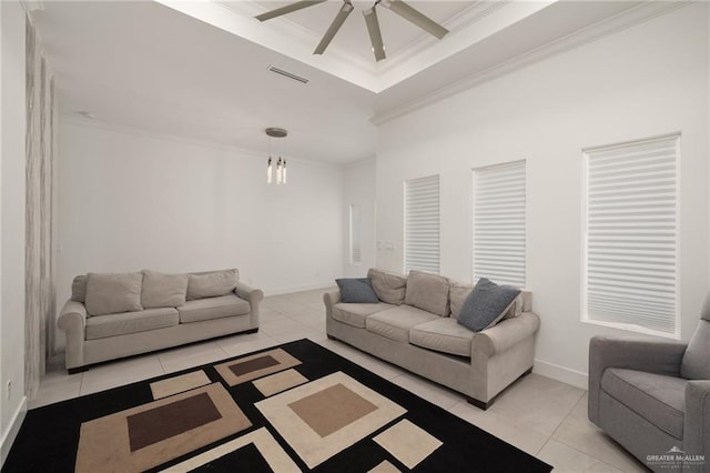 living area with ceiling fan, crown molding, baseboards, light tile patterned floors, and a chandelier