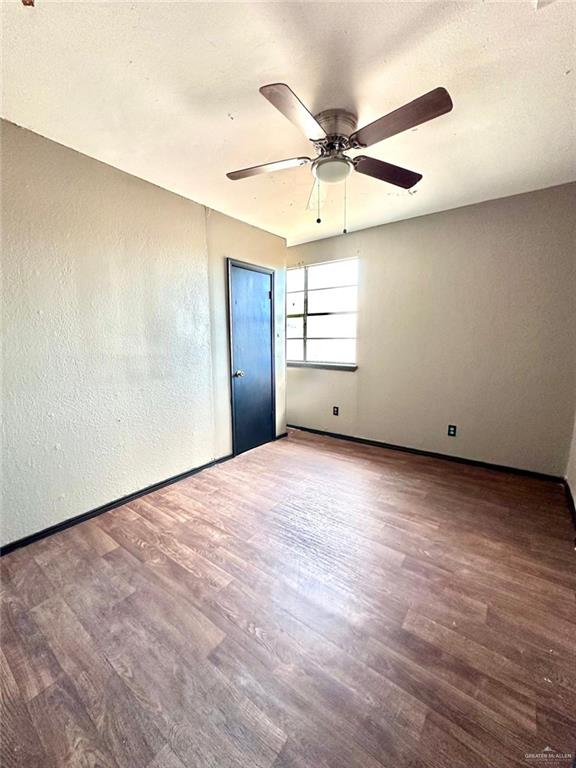 unfurnished room featuring ceiling fan and wood-type flooring