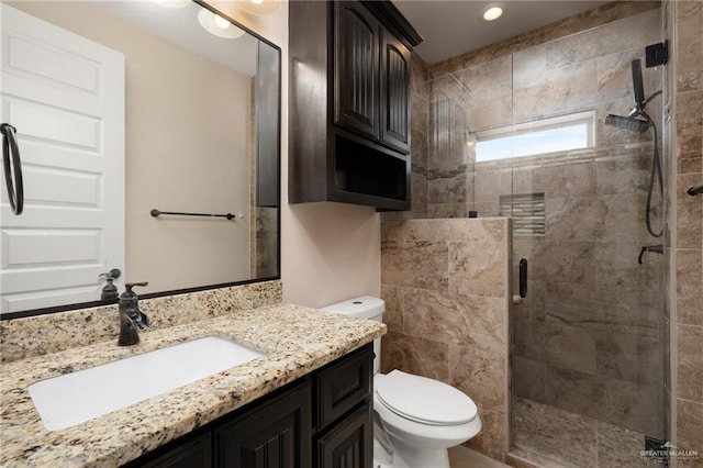 bathroom with vanity, toilet, and walk in shower