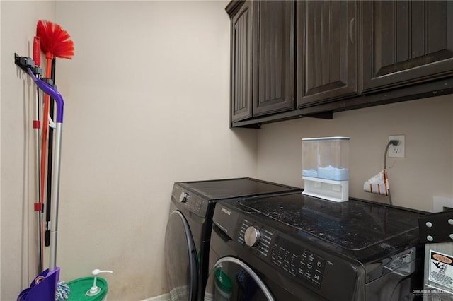 laundry area with cabinets and washing machine and clothes dryer