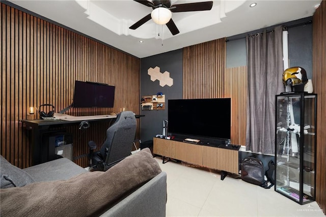 office space with a raised ceiling and ceiling fan