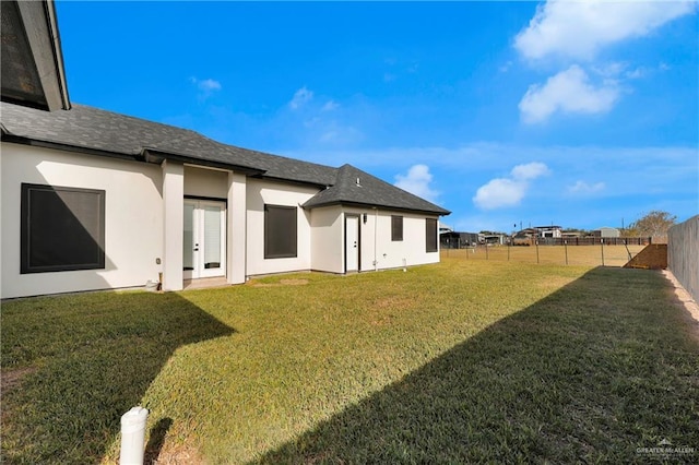 back of house featuring a yard