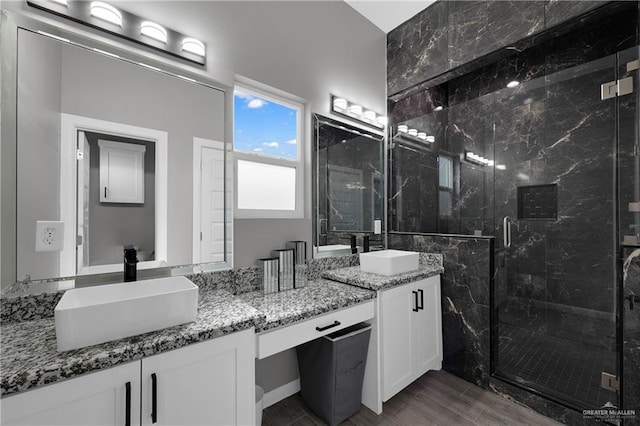 bathroom with vanity, hardwood / wood-style floors, and an enclosed shower