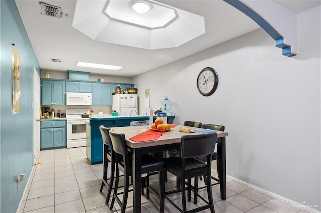 dining space with light tile patterned floors