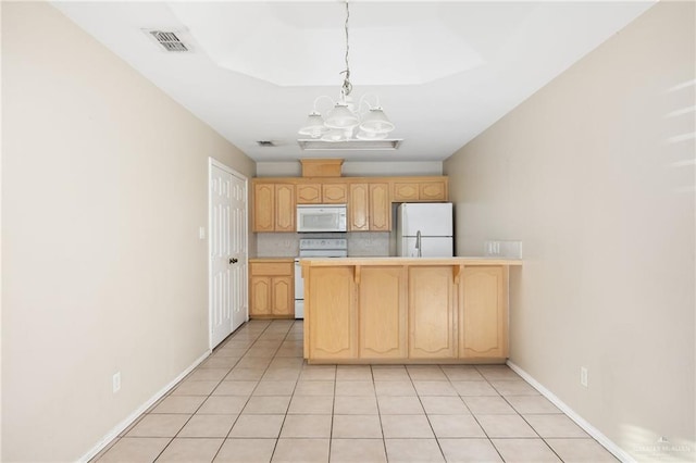 kitchen featuring light brown cabinets, tasteful backsplash, a chandelier, decorative light fixtures, and white appliances