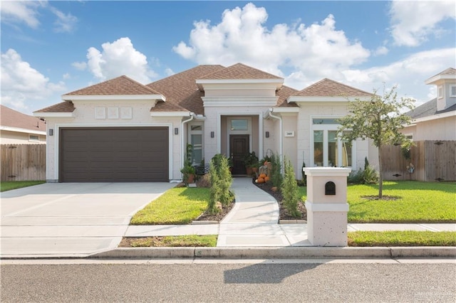 view of front of property with a garage and a front lawn