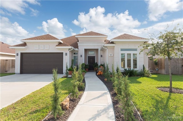 view of front of home with a garage and a front lawn