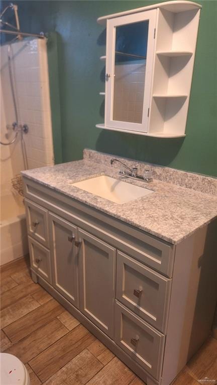 bathroom with vanity, wood-type flooring, and toilet