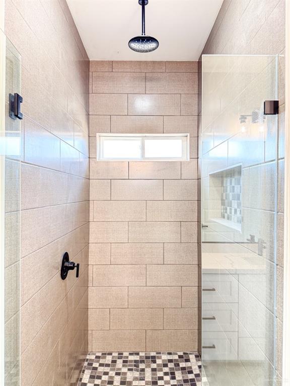 bathroom with tiled shower