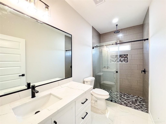 bathroom with vanity, toilet, and walk in shower