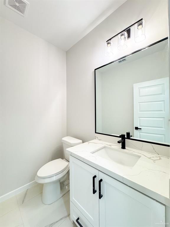 bathroom with vanity and toilet