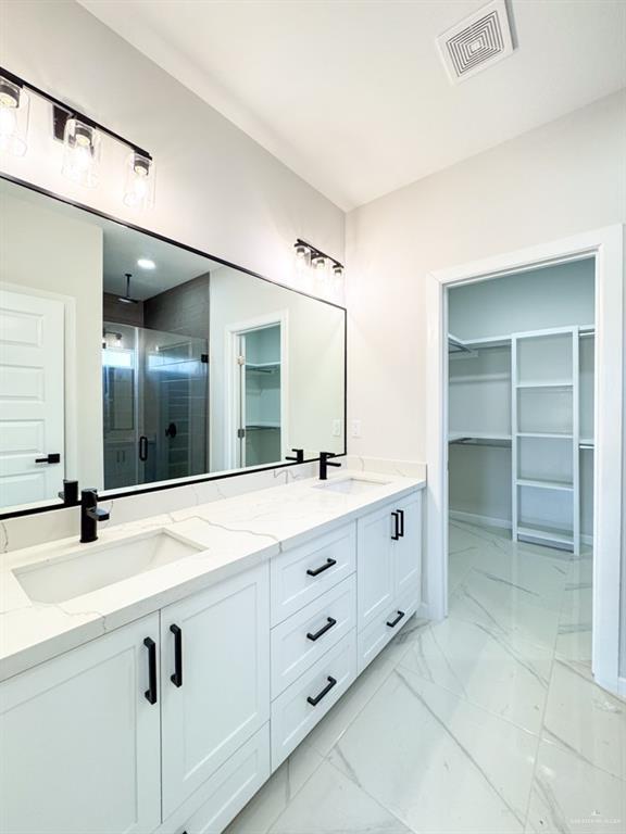 bathroom with vanity and an enclosed shower