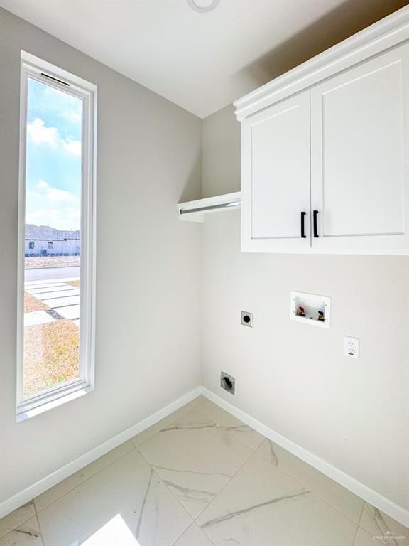 washroom featuring cabinets, hookup for a washing machine, plenty of natural light, and hookup for an electric dryer