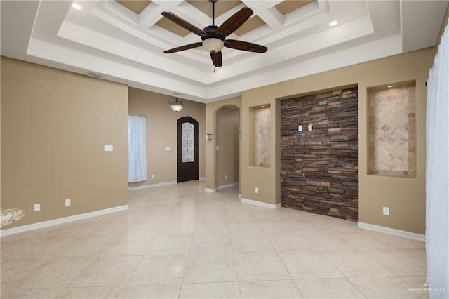 spare room with a raised ceiling, ceiling fan, light tile patterned floors, and coffered ceiling