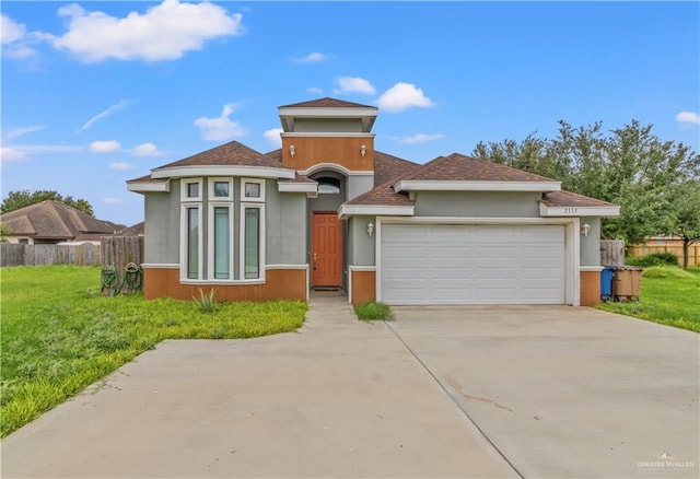 view of front of property with a front yard and a garage