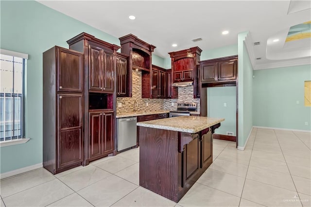 kitchen with a center island, backsplash, light stone countertops, light tile patterned floors, and stainless steel appliances