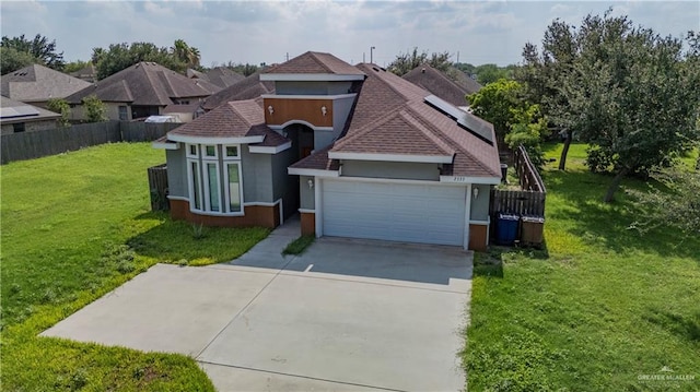 view of front of home featuring a garage and a front lawn