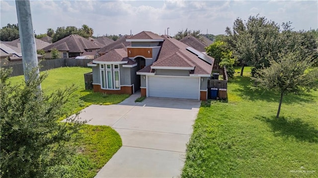 view of front of property featuring a front yard and a garage