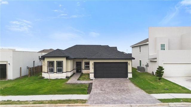 3609 E Santorini Dr, Edinburg, TX 78542 - view of front of property with a garage, a front yard, stucco siding, and driveway