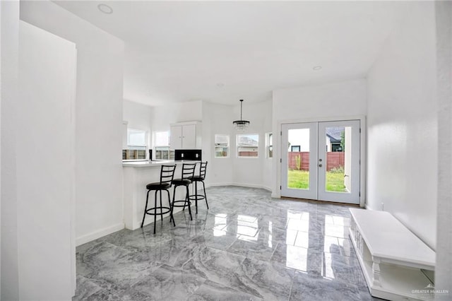 3609 E Santorini Dr, Edinburg, TX 78542 - dining area with french doors, marble finish floor, and baseboards