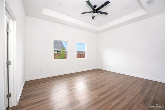 3609 E Santorini Dr, Edinburg, TX 78542 - unfurnished bedroom with baseboards, visible vents, dark wood-style flooring, and a raised ceiling