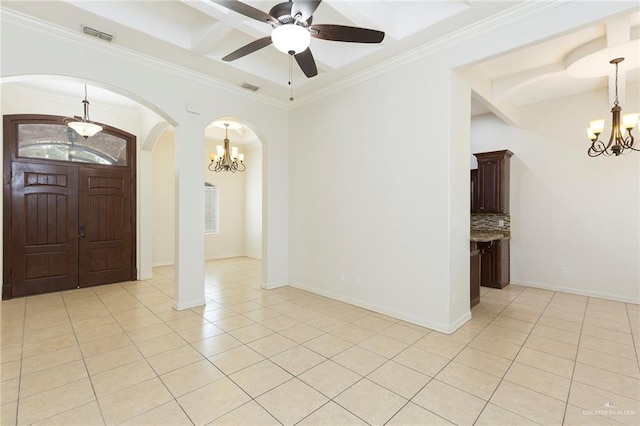 tiled foyer with beam ceiling, ceiling fan with notable chandelier, and crown molding