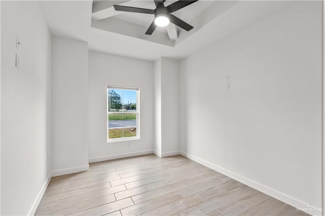 unfurnished room featuring ceiling fan and a raised ceiling