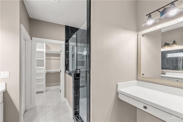 bathroom featuring vanity and an enclosed shower