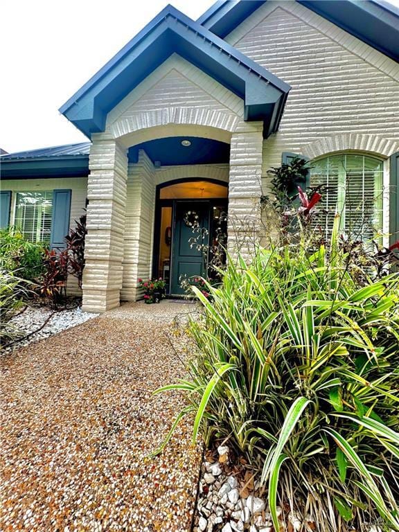 entrance to property featuring brick siding