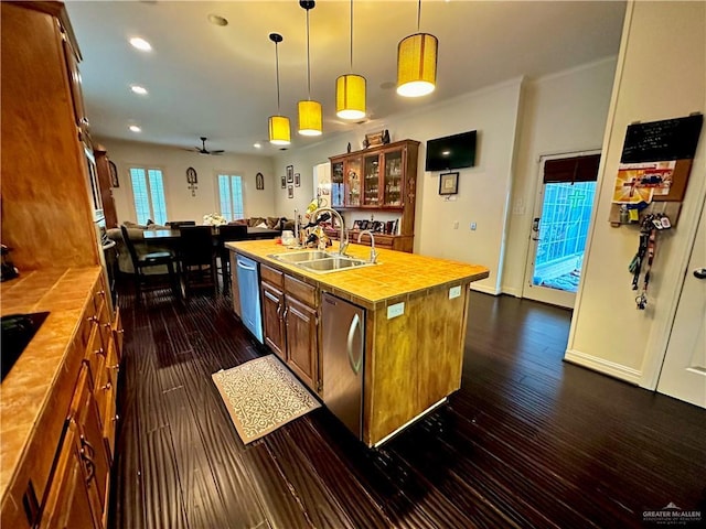 kitchen with a sink, decorative light fixtures, recessed lighting, dark wood finished floors, and stainless steel dishwasher