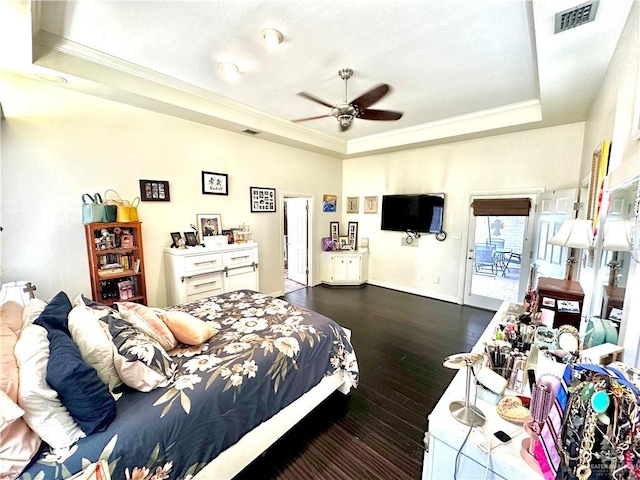 bedroom with crown molding, a raised ceiling, visible vents, and access to exterior