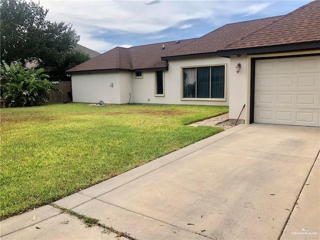 exterior space featuring a lawn and a garage