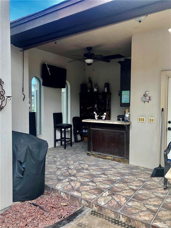 view of patio featuring ceiling fan