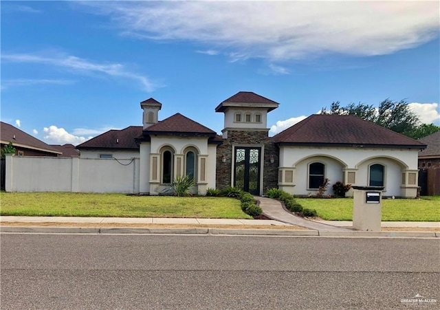 mediterranean / spanish-style house featuring a front lawn