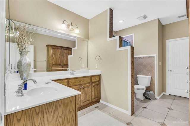 2504 Wernecke Ave, Mission, TX 78574 - bathroom with tile patterned flooring, double vanity, toilet, and tile walls