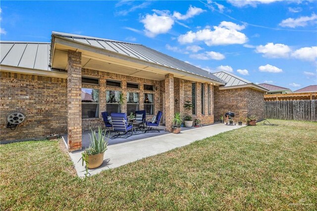 2504 Wernecke Ave, Mission, TX 78574 - back of house with a standing seam roof, brick siding, and metal roof