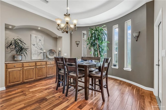 2504 Wernecke Ave, Mission, TX 78574 - dining space with wood finished floors, plenty of natural light, a chandelier, crown molding, and baseboards