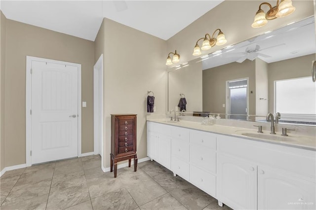 2504 Wernecke Ave, Mission, TX 78574 - bathroom featuring double vanity, a ceiling fan, and baseboards