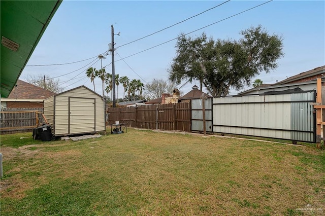 view of yard featuring an outbuilding, a storage unit, and a fenced backyard