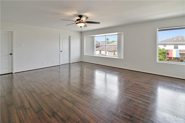 spare room with ceiling fan and dark wood-type flooring