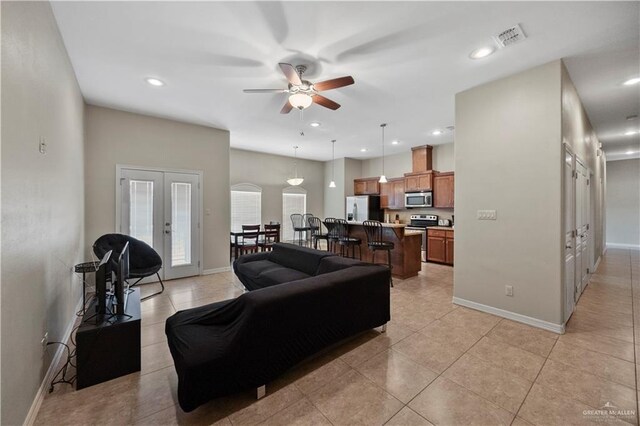2715 Mimosa St Unit 9, Mission, TX 78572 - living room featuring ceiling fan, baseboards, french doors, light tile patterned floors, and recessed lighting