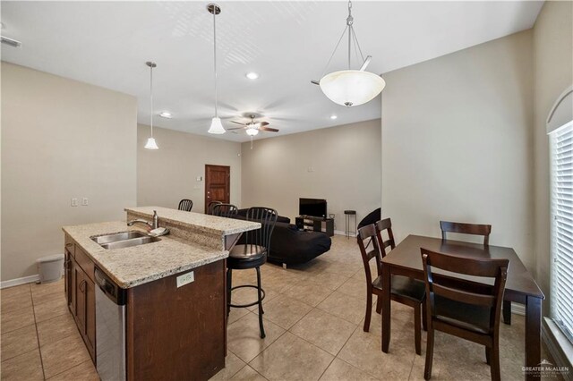 2715 Mimosa St Unit 9, Mission, TX 78572 - kitchen featuring a sink, a breakfast bar, dishwasher, light tile patterned floors, and recessed lighting